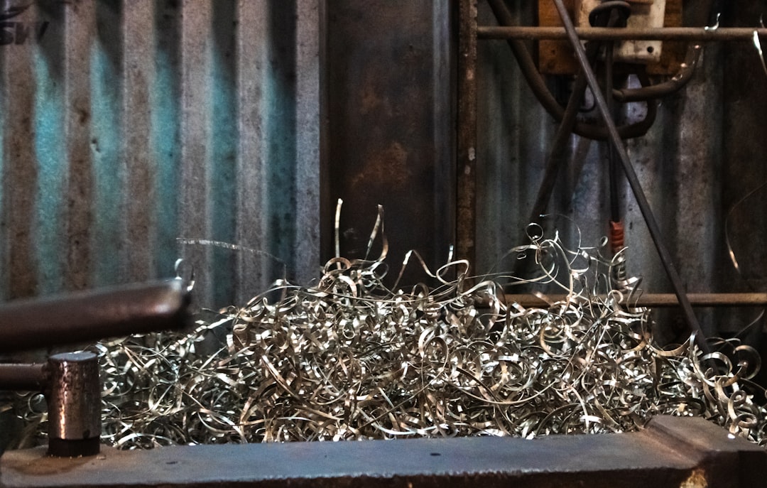 Metal shavings pile up on a workbench. | The National Recycling Corporation