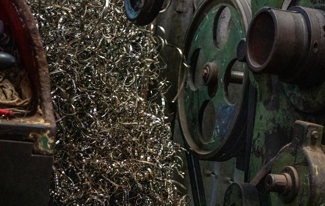 Metal shavings piled next to industrial machinery. | The National Recycling Corporation
