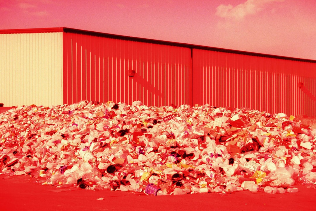 a large pile of trash sitting in front of a building | The National Recycling Corporation