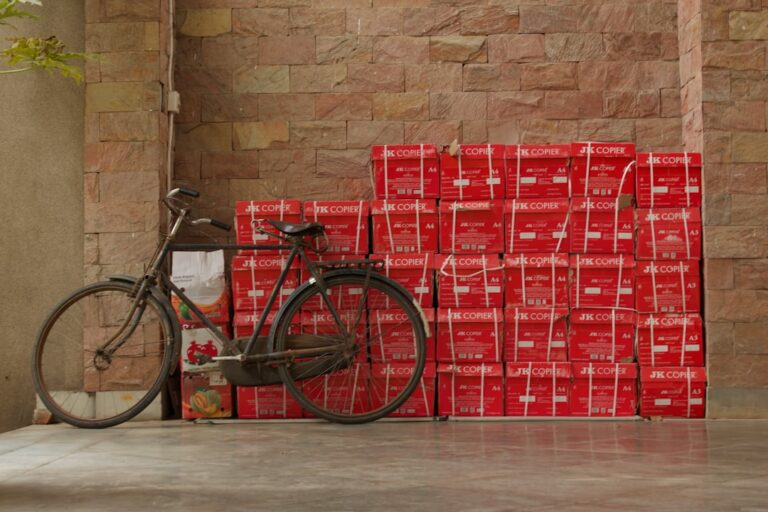 A bicycle parks next to a pile of boxes. | The National Recycling Corporation