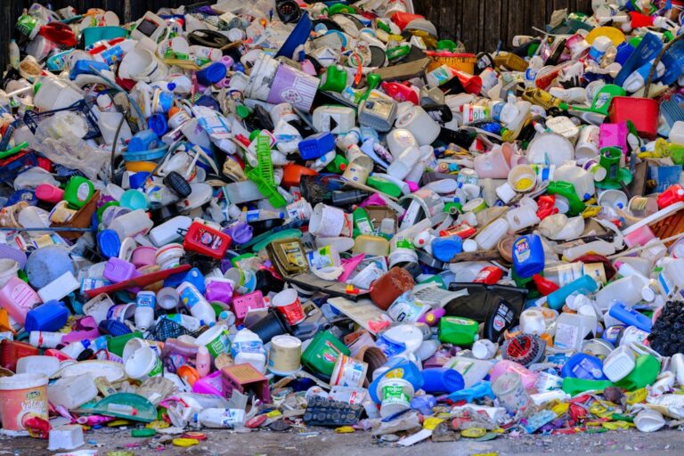 A pile of plastic bottles sitting on top of a street | The National Recycling Corporation