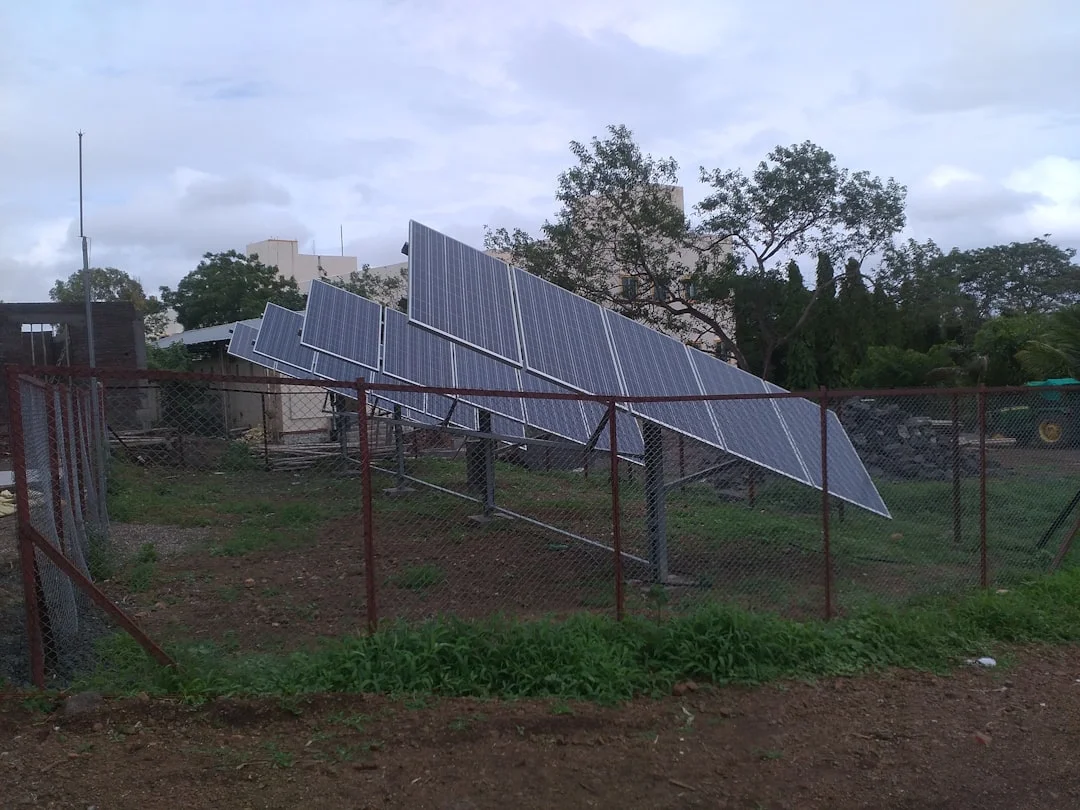 a fence with a bunch of solar panels on top of it | The National Recycling Corporation
